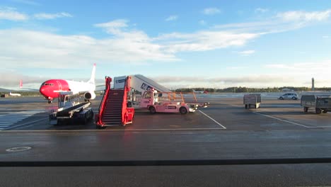 Norwegian-plane-parking-at-Oslo-Gardermoen-airport,-Norway,-in-September-2015