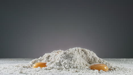 Yolks-fall-on-flour-creating-a-splash-in-slow-motion