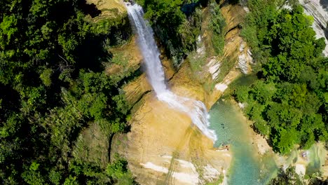 POV-looking-down-over-rocky-cascading-fresh-waterfall-scenery-in-lush,-tropical-Bohol-jungle-scenery