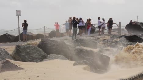 Gruppen-Von-Menschen-Kommen,-Um-Sich-Die-Schäden-An-Einem-Strand-Anzusehen,-Die-Durch-Einen-Sich-Entwickelnden-Zyklon-Verursacht-Wurden