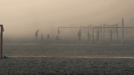 Dense-sea-fog-covering-soccer-field-at-the-beach-during-sunset