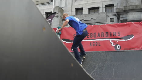 Experienced-skater-performs-a-sweeper-trick-on-a-wooden-ramp-in-the-city