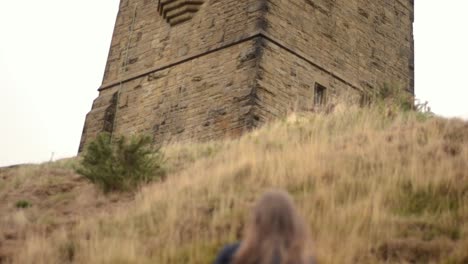 Woman-climbs-banking-up-to-Castle-Hill