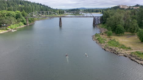 Bridge-over-river-dolly-back-willamette-river-aerial-with-boats