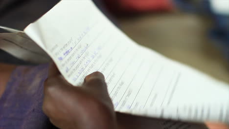 Ugandan-student-writing-'beautiful'-on-a-test
