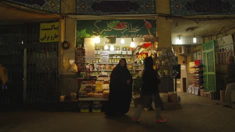 Iranian-Women-buying-from-a-shop-selling-spices-in-the-Tajrish-Bazaar-in-Tehran,-Iran