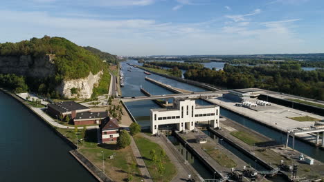 AERIAL-SLOMO:-Shot-of-a-lock-and-its-infrastructure-and-a-canal-on-a-sunny-day