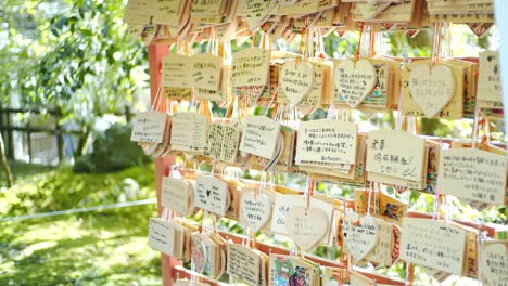 Praying-in-front-of-a-shrine-in-Kyoto,-Japan-soft-lighting-slow-motion