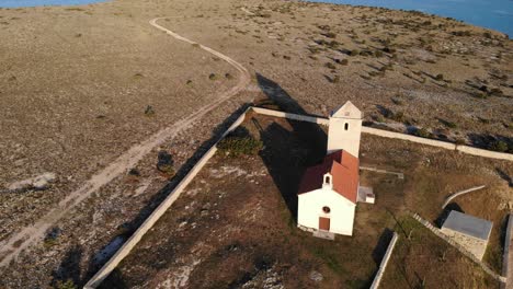 Aerial-view-of-the-rural-church-on-the-island-Zecevo,-Zadar-county-Croatia-in-sunset