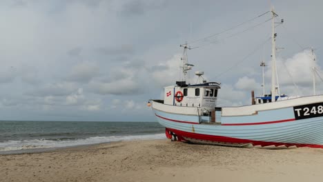 Fisherman-boats-at-the-beach-in-summer-with-cloudy-sky-and-waves-in-the-sea