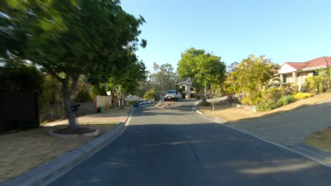 Rear-facing-driving-point-of-view-POV-of-quiet-Australian-suburban-city-street---ideal-for-interior-car-scene-green-screen-replacement