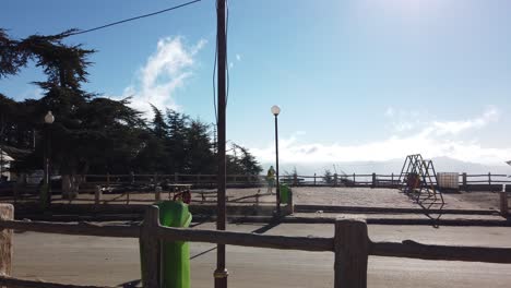 Two-workers-cleaning-asphalt-road-from-trash-using-sweeper-,in-sunny-day,-in-small-town-called-CHREA-,-in-algeria