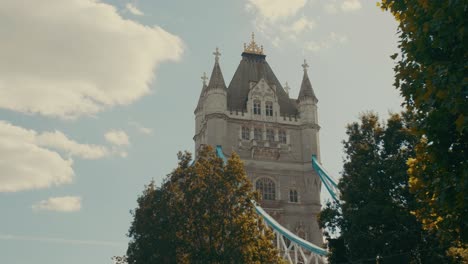 Close-up-shot-of-a-London-Bridge-tower-with-trees-on-foreground-in-United-Kingdom