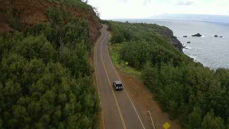 Cinematic-Aerial-View,-Jeep-Drives-Around-Maui-Coastline-In-Hawaii