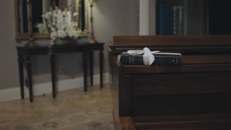 Old-Book-Wrapped-with-a-Ribbon-Laying-on-Top-of-a-Wooden-Piano