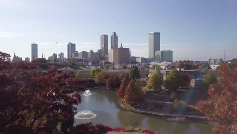 Aerial-drone-footage-of-Tulsa-breaking-through-the-trees-in-Autumn