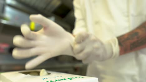 Cook-putting-on-latex-gloves-before-cooking