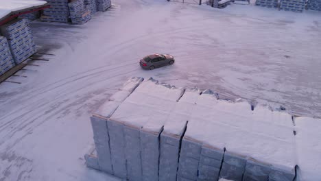 Aerial-view-of-sport-car-drifting-in-slow-motion-over-ice