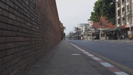 Very-few-vehicles-on-the-street-near-Thapae-Gate,-the-iconic-place-of-Chiang-Mai-city,-on-a-weekday-morning-during-a-lockdown-due-to-COVID-19-pandemic