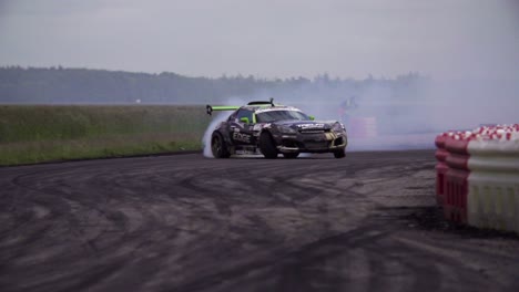 Opel-GT-and-BMW-E36-Touring-drifting-on-a-drift-track-in-super-slow-motion-with-lots-of-smoke-from-the-tyres-and-close-racing