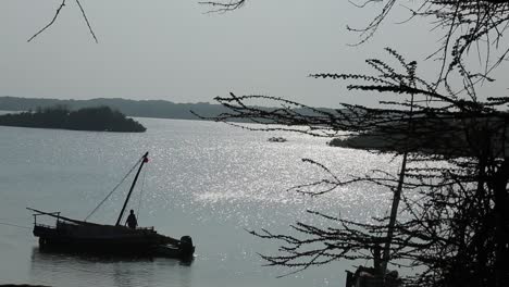 A-man-docking-a-boat-at-the-shore-of-Indian-ocean