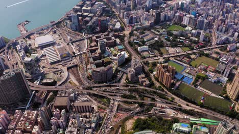 Hong-Kong-skyline,-Slow-aerial-pass-heading-towards-Victoria-Harbour,-above-Kowloon-bay-and-urban-area