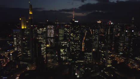 Night-view-of-skyscrapers-in-downtown-business-district-near-river-in-Germany