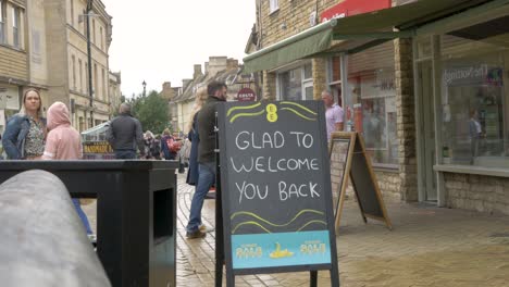 Business-welcomes-back-customers-queuing-to-enter-shop