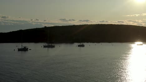 A-video-of-a-bunch-of-anchored-sail-boats-in-between-the-two-islands