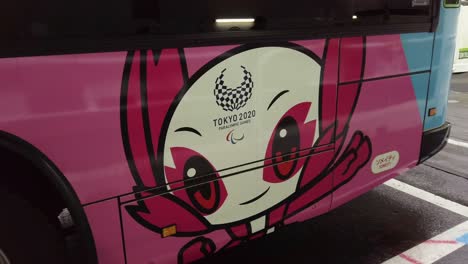 Tokyo-Olympics-twentytwenty-and-Paralympics-logo-on-a-bus-in-Shibuya,Tokyo,Japan