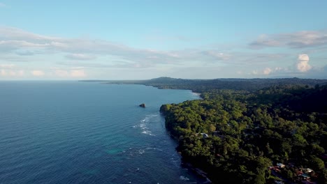 Drone-flying-away-in-the-wide-blue-sky-over-the-Caribbean-sea-in-Puerto-Viejo-de-Talamanca-in-Costa-Rica