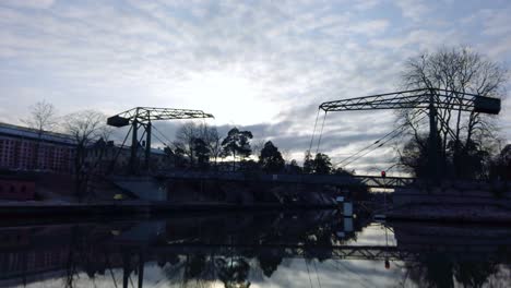 Pan-right-of-a-drawbridge-and-reflection-Trollhattan,-Sweden