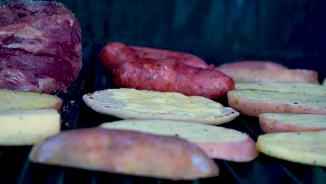 Closeup-shot-grilled-meat-with-chorizos,-cheesetop-tortillas,-guatemalan-beans-and-grilled-potatoes-smoking-and-juicy-preparation-ready-to-eat-family-at-a-summer-season-day-[HD1920-x-1080]-fps-29