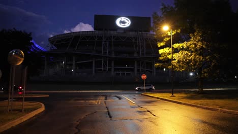 Beaver-Stadium-at-Penn-State-University-at-night-with-cars-driving-by