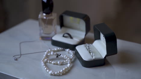 Jewelry-silver,-diamond,-necklace,-bracelet,-rings-placed-on-table-before-wedding-day