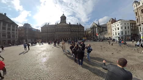 People-At-The-Dam-Square-On-A-Sunny-Day-In-Amsterdam,-Netherlands