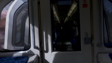 Interior-View-Inside-A-Jubilee-Line-Train-Looking-Through-Door-Into-Next-Carriage