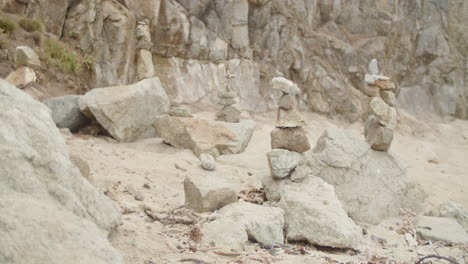 Wide-shot-pan-over-a-series-of-cairns-on-a-beach-in-Northern-California