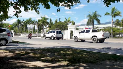 Daily-sight-of-traffic-driving-around-the-Government-Palace-parliament-building-in-capital-Dili,-Timor-Leste,-Southeast-Asia