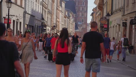 Video-of-huge-number-of-people-are-walking-in-the-street-of-Kraków,-Poland-on-a-sunny-day