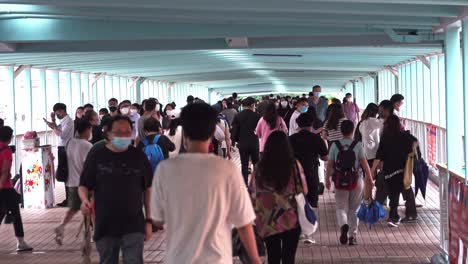 People-Walking-in-the-Pedestrian-Bridge-in-Mong-Kok,-Hong-Kong