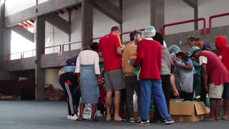 Homeless-people-gather-to-receive-clothes-and-food-in-George,-Western-Cape,-South-Africa