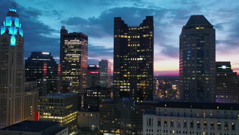 Aerial-view-of-skyscrapers-in-downtown-Columbus,-during-dusk---pull-back,-drone-shot