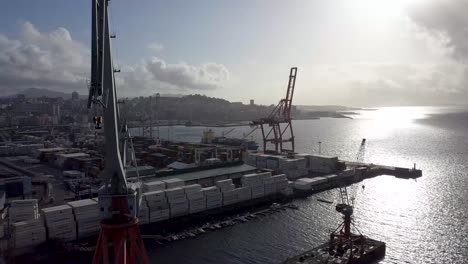 Aerial-approach-view-of-the-port-of-Vigo-at-sunset-while-lockdown-with-the-city-and-the-sea-in-the-background