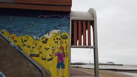 Wall-Mural-Clacton-on-sea-Essex,-England-pier-in-background-Handheld-pan-footage