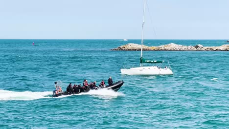 Eine-Gruppe-Von-Tauchern-In-Einem-Schnellboot-Reist-Zum-Tauchplatz,-Während-Sie-An-Einem-Sonnigen-Tag-Am-Hafen-Von-Coliemore-Vorbeifährt