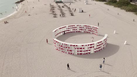 Orbiting-aerial-of-Dreaming-with-Lions-artwork-on-Miami-Beach-sand