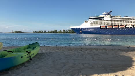 Sandy-beach-and-a-large-cruise-ship-passing-by