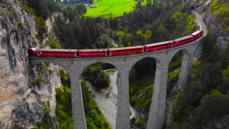 Aerial:-red-train-on-the-Landwasser-viaduct