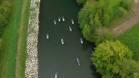 Paddle-boarding-with-bird-view-drone-shot-flying-above-the-people